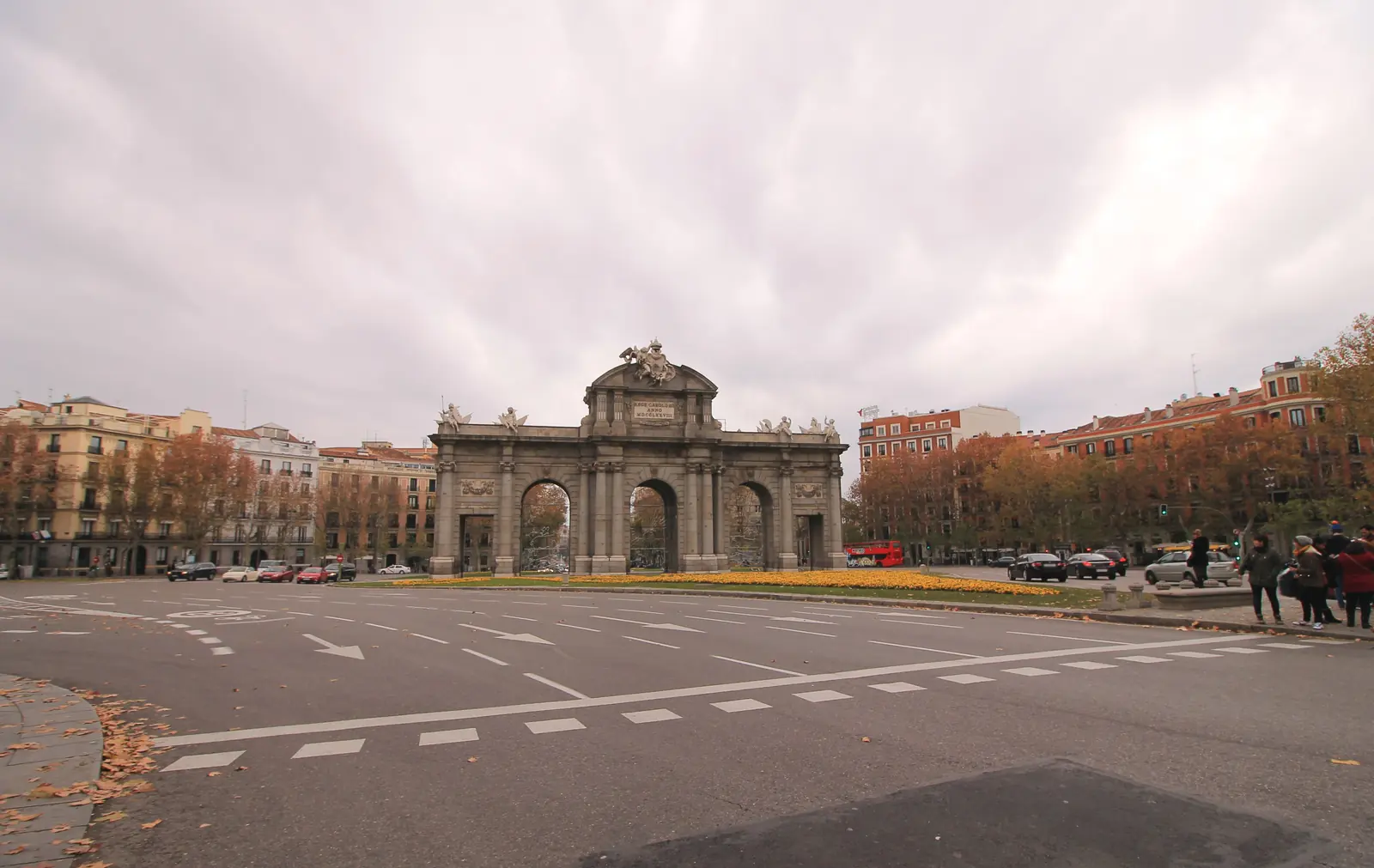 The Puerta de Alcalá seen across the Plaza de la Independencia in Madrid under a cloudy sky